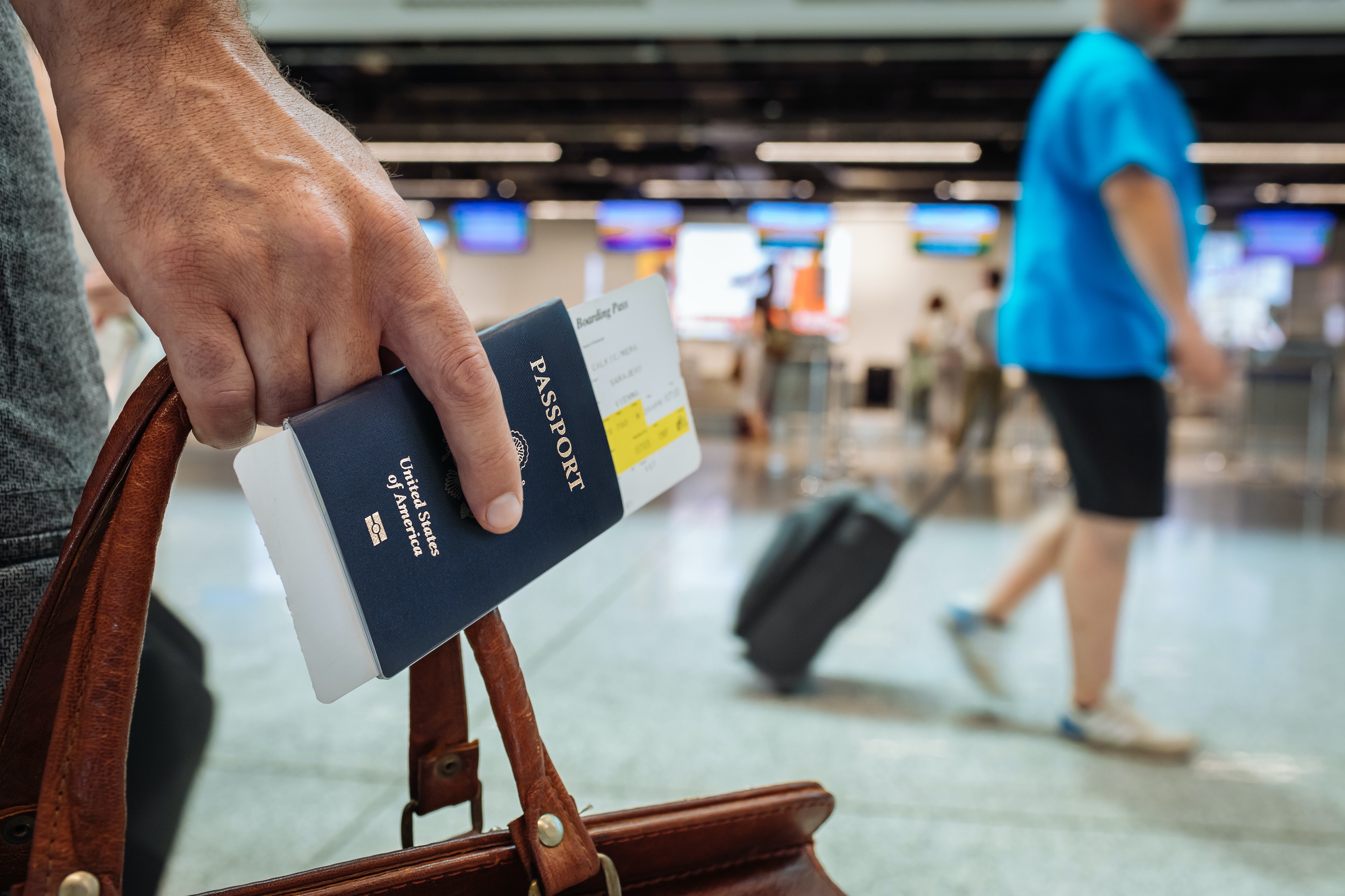 Traveler holding passport and bag