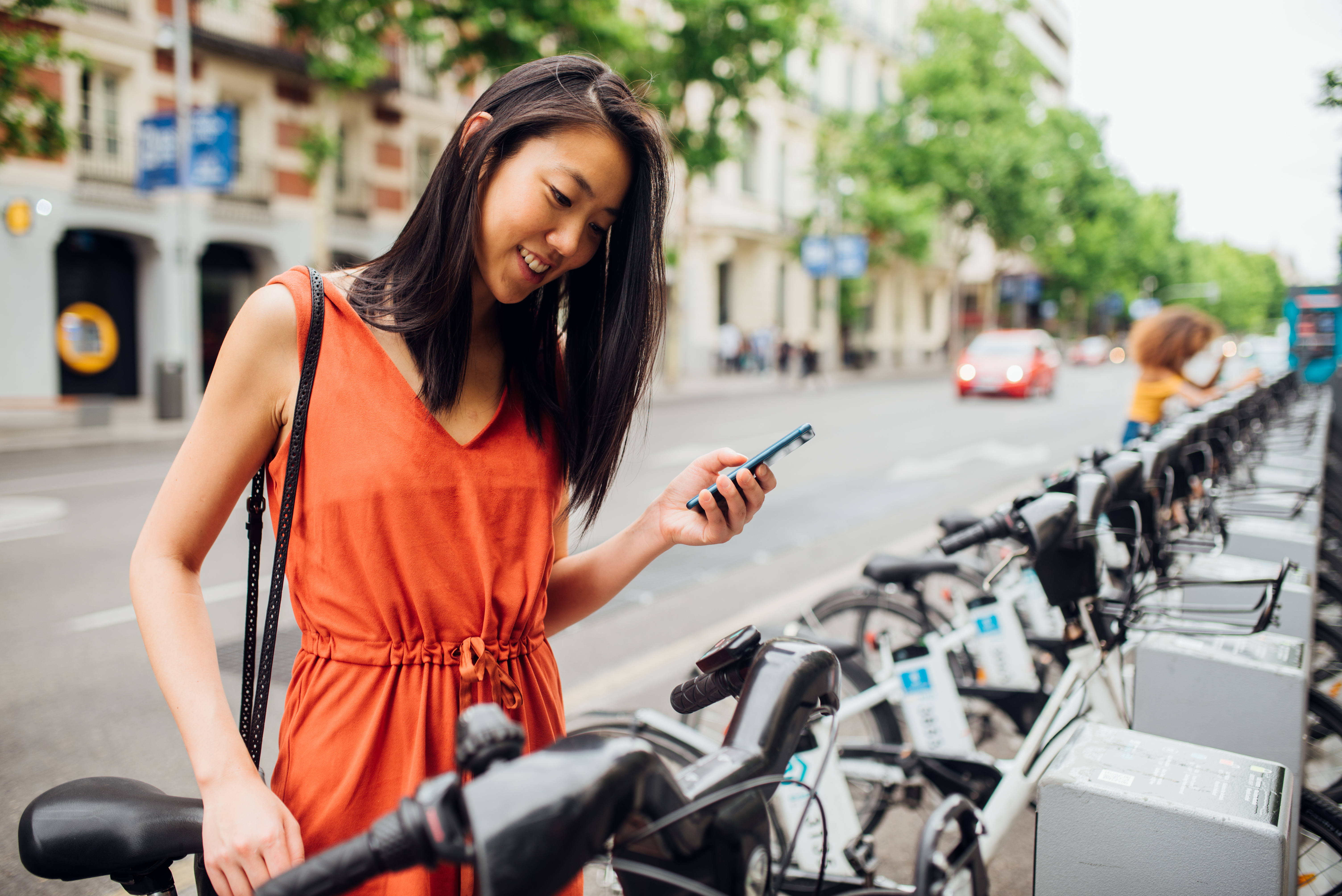 Person looking at phone while renting bikeshare