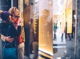 couple looking at holiday window display