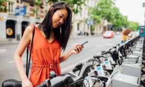 Person looking at phone while renting bikeshare
