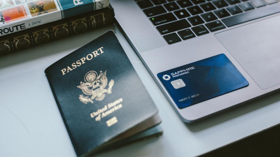 Image of passport, credit card, laptop