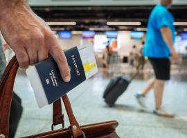 Traveler holding passport and bag