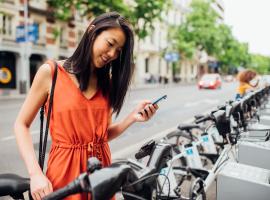 Person looking at phone while renting bikeshare