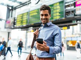 person looking at phone in airport 