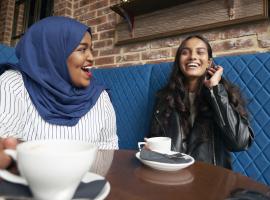 two people talking and enjoying coffee 