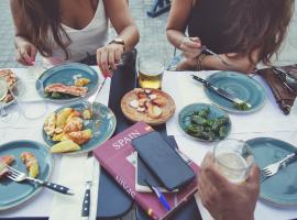 group of friends around a table with food