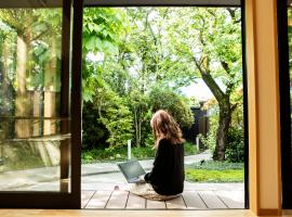 person sitting outside on laptop