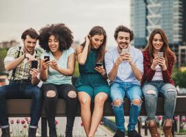 group of friends looking a phones