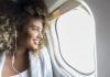 person looking out plane window