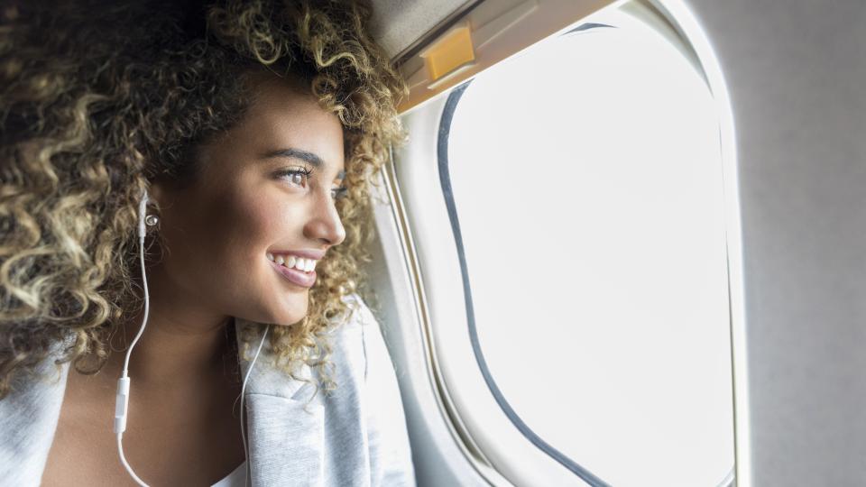 person looking out plane window